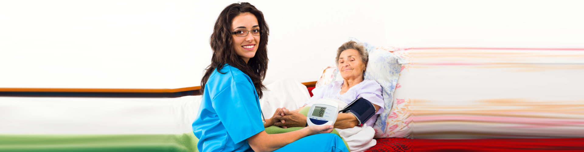 Nurse using digital blood pressure for senior patient.